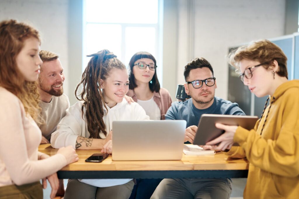 Team begutachtet Dokumente auf Laptop